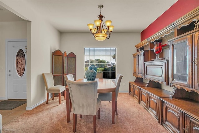 dining area with a notable chandelier and light colored carpet