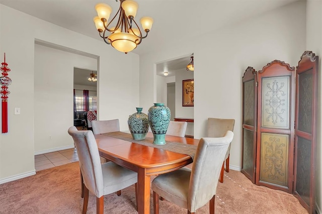 carpeted dining space featuring an inviting chandelier