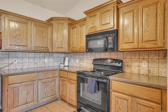 kitchen featuring decorative backsplash, light tile patterned floors, vaulted ceiling, and black appliances