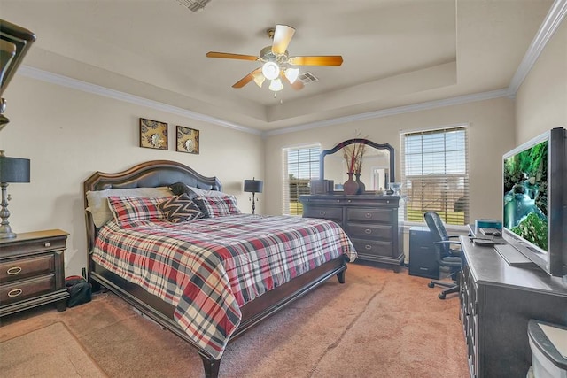 carpeted bedroom featuring ceiling fan, a raised ceiling, crown molding, and multiple windows