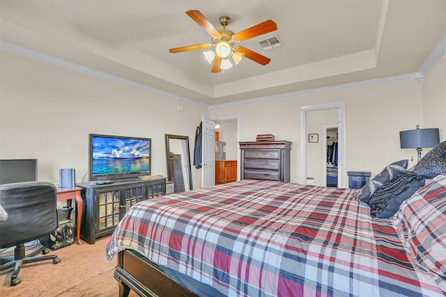 bedroom featuring carpet flooring, a raised ceiling, ceiling fan, and ornamental molding