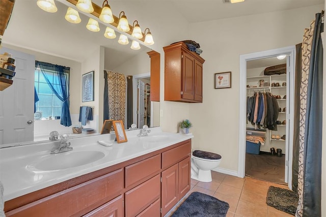 bathroom featuring tile patterned floors, vanity, and toilet