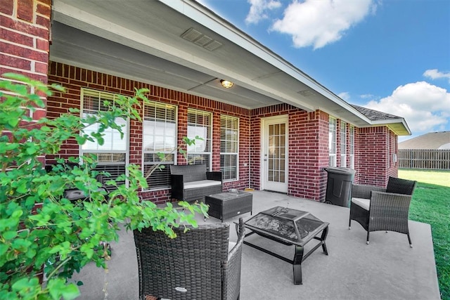 view of patio / terrace with an outdoor living space with a fire pit