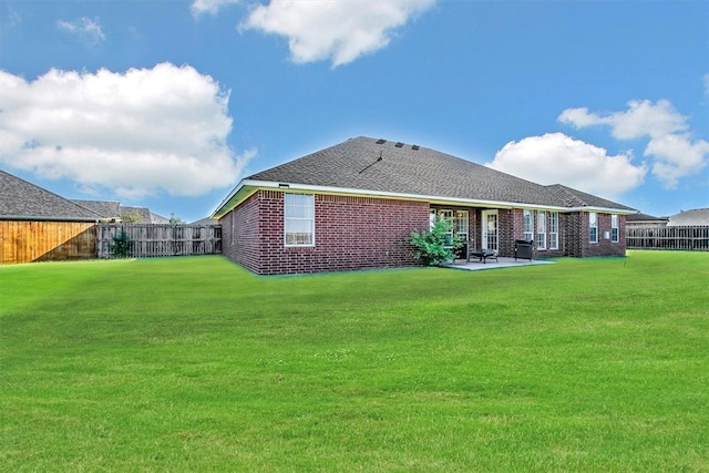 back of house featuring a patio area and a yard