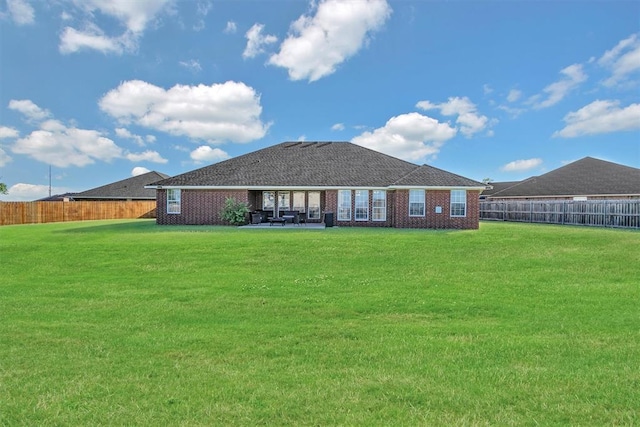 rear view of property with a patio area and a lawn