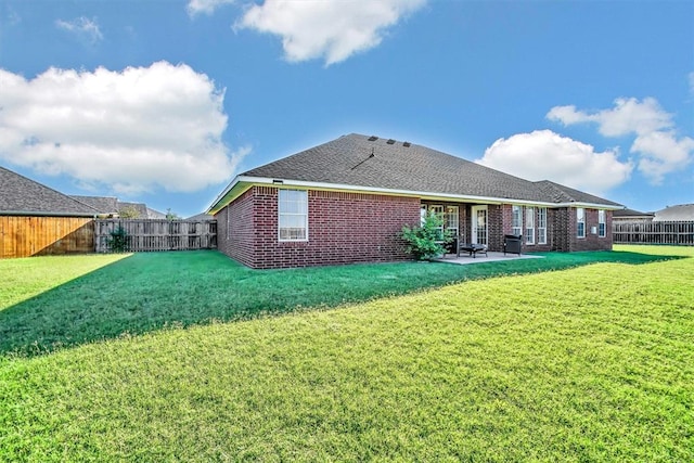 rear view of property featuring a lawn and a patio area