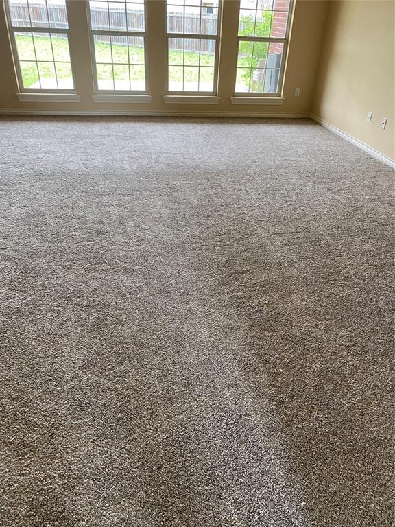 unfurnished room featuring carpet flooring and baseboards