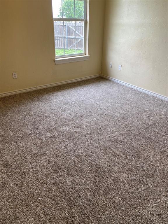 carpeted spare room with baseboards