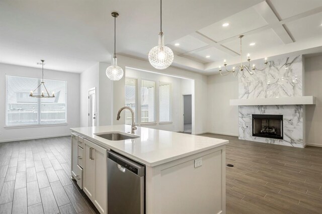2405 Crystal Creek Dr, Yukon, OK 73099 - kitchen featuring stainless steel dishwasher, a chandelier, coffered ceiling, dark wood finished floors, and a kitchen island with sink