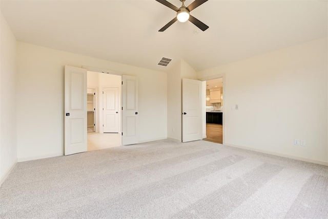 unfurnished bedroom featuring ceiling fan, light carpet, and lofted ceiling