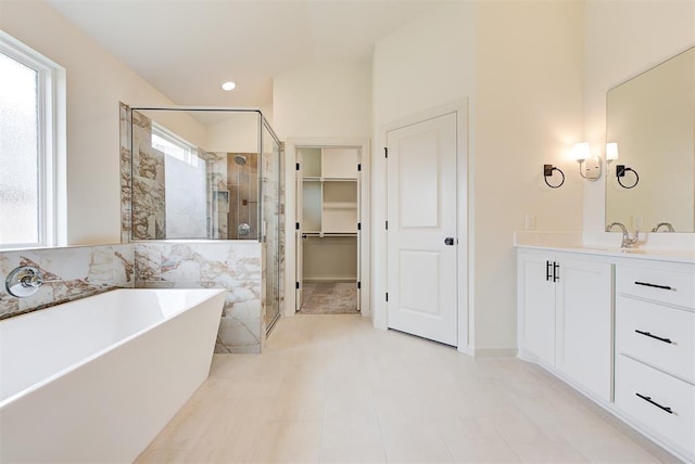 2405 Crystal Creek Dr, Yukon, OK 73099 - bathroom with a stall shower, a freestanding tub, vanity, and a spacious closet