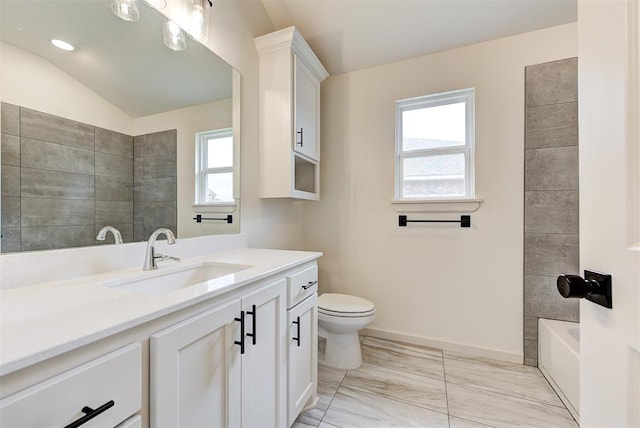 bathroom with vanity, lofted ceiling, and toilet