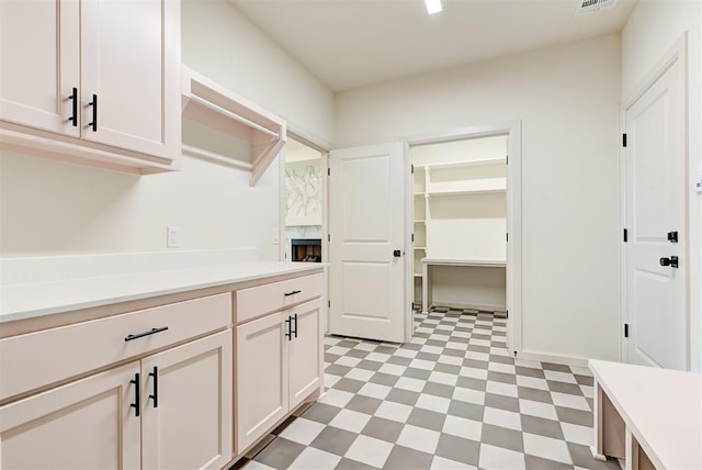 laundry area with a high end fireplace and cabinets