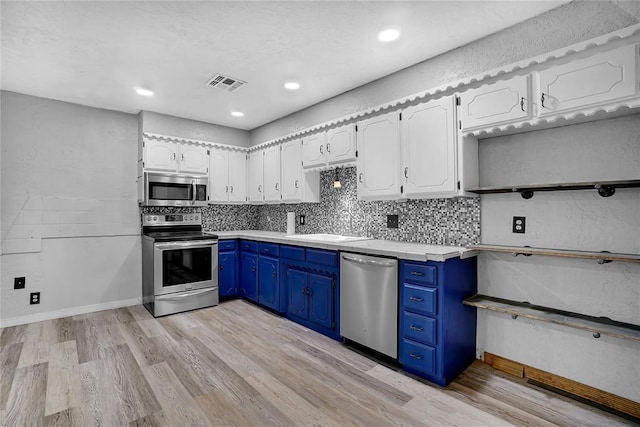 kitchen featuring backsplash, stainless steel appliances, blue cabinetry, light hardwood / wood-style floors, and white cabinetry