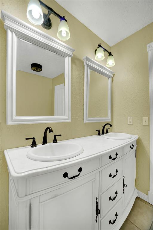 bathroom featuring tile patterned flooring and vanity