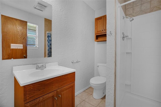 bathroom with tile patterned floors, a shower with curtain, vanity, and toilet