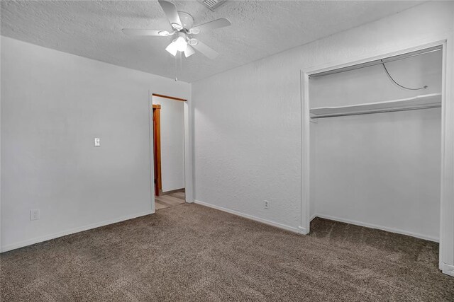 unfurnished bedroom featuring carpet, a textured ceiling, a closet, and ceiling fan