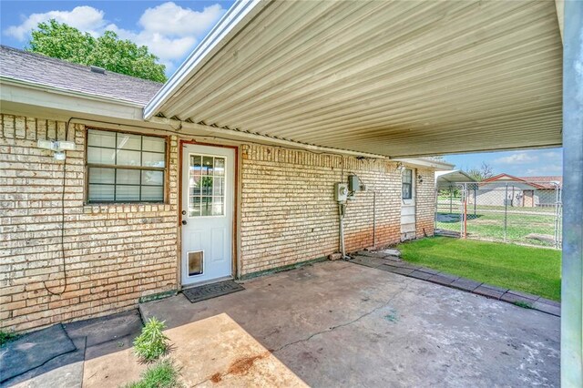 view of exterior entry with a patio