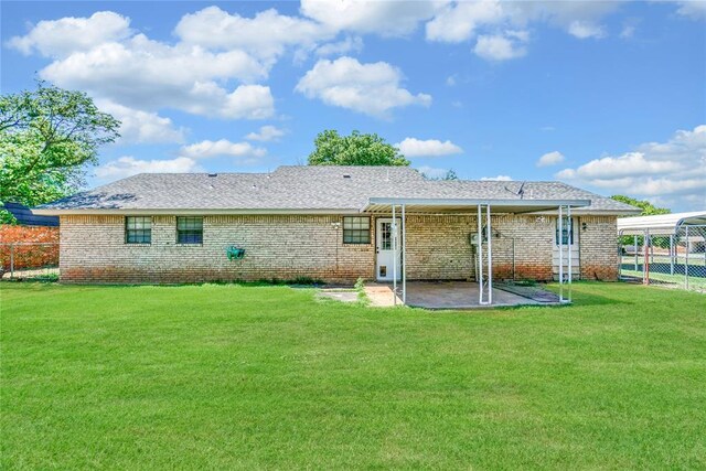 back of house featuring a lawn and a patio