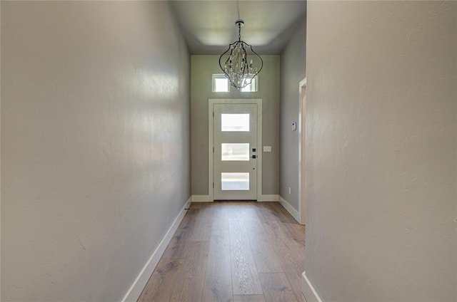 entryway featuring a notable chandelier and light hardwood / wood-style flooring