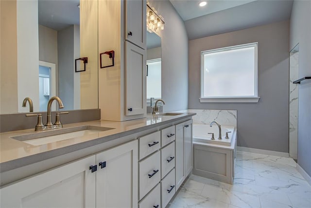 bathroom with vanity and a bath