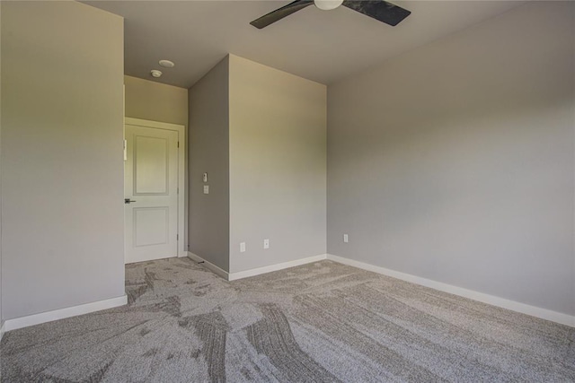 empty room with ceiling fan and light colored carpet