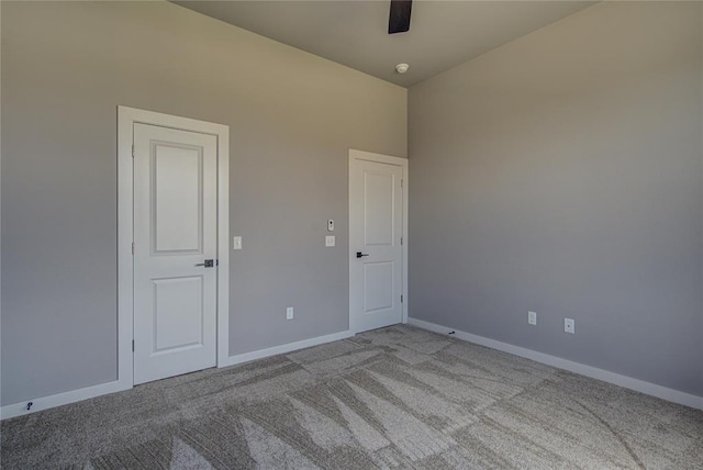 spare room with light colored carpet and ceiling fan