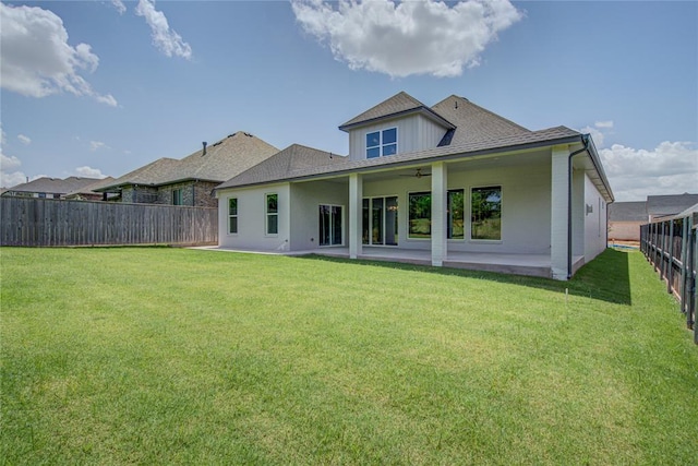 back of property featuring a patio, ceiling fan, and a lawn