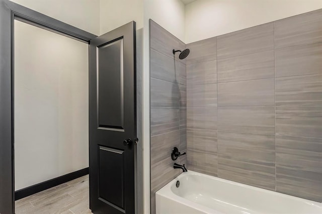 bathroom featuring hardwood / wood-style floors and tiled shower / bath