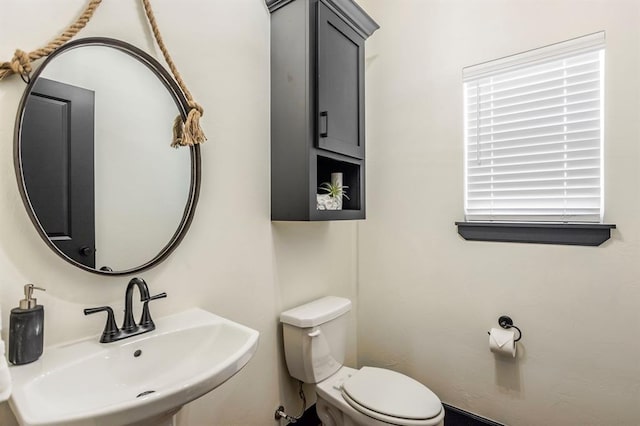 bathroom featuring toilet and sink