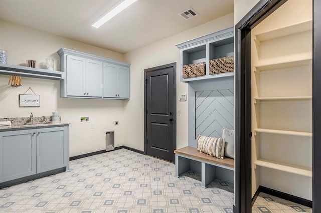 clothes washing area featuring washer hookup, electric dryer hookup, cabinets, and sink