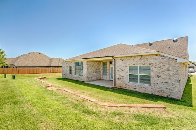 rear view of house featuring a patio and a lawn