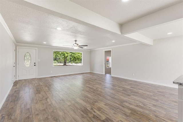 unfurnished living room with ornamental molding, a textured ceiling, ceiling fan, beamed ceiling, and hardwood / wood-style floors