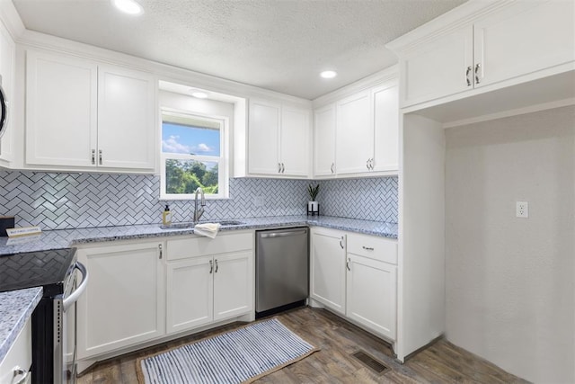 kitchen with dark wood-type flooring, sink, appliances with stainless steel finishes, light stone counters, and white cabinetry