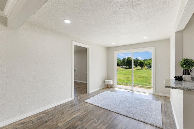 interior space with hardwood / wood-style floors and a textured ceiling