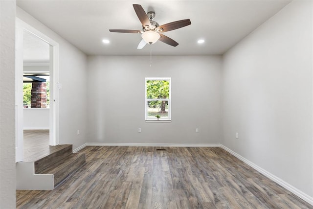 unfurnished room with ceiling fan and dark hardwood / wood-style flooring