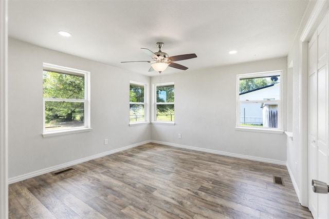 unfurnished room featuring ceiling fan and hardwood / wood-style flooring