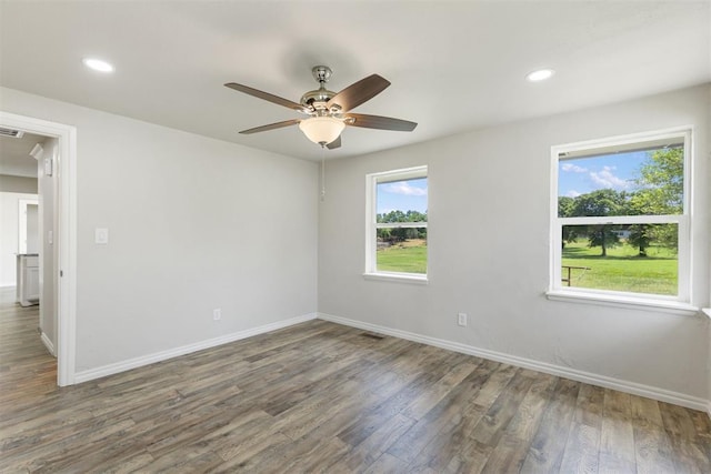 empty room with ceiling fan and dark wood-type flooring