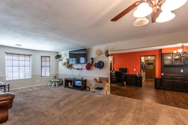 living room with dark wood-type flooring and an inviting chandelier