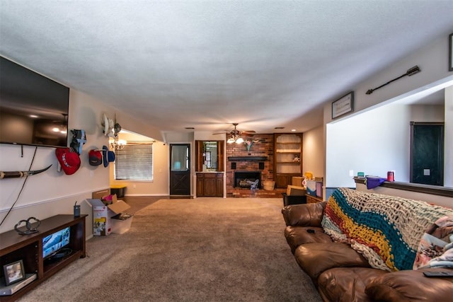 carpeted living room with a fireplace and ceiling fan with notable chandelier