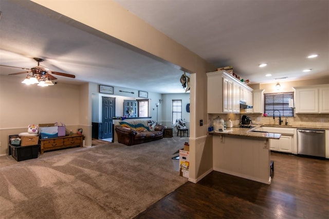 kitchen featuring backsplash, ceiling fan, dark wood-type flooring, dishwasher, and white cabinetry