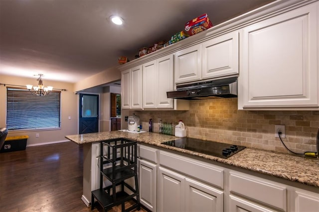 kitchen featuring black electric stovetop, dark hardwood / wood-style flooring, decorative light fixtures, white cabinets, and a chandelier