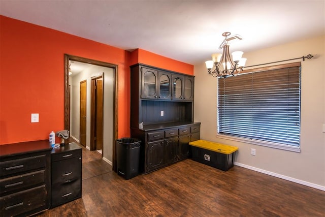 kitchen with decorative light fixtures, dark hardwood / wood-style floors, and a notable chandelier