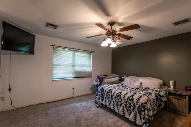 carpeted bedroom with ceiling fan and a textured ceiling