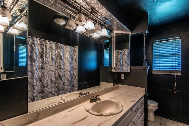 bathroom with tile patterned floors, vanity, and toilet