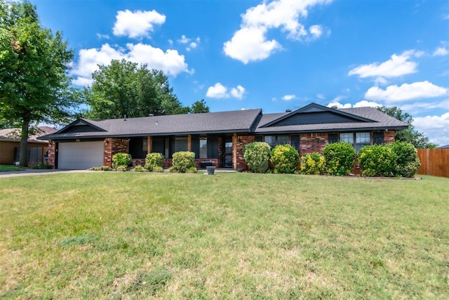 ranch-style house featuring a front yard and a garage