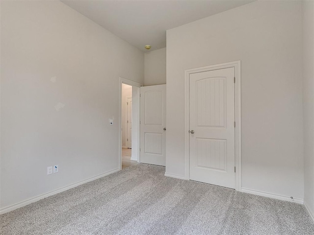 unfurnished bedroom with light colored carpet