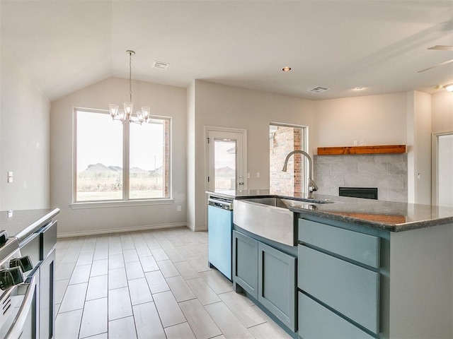 kitchen with stainless steel appliances, sink, pendant lighting, a notable chandelier, and lofted ceiling