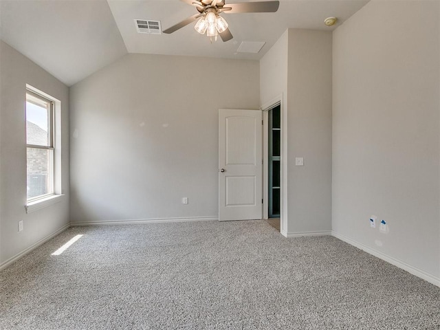 carpeted empty room with ceiling fan and lofted ceiling