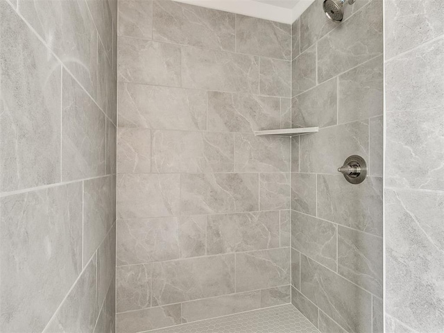 bathroom with tiled shower